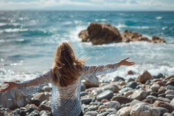 Fototapeta na wymiar Woman Meditating on Rocky Beach: Breathing Fresh Air and Finding Harmony