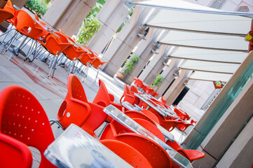 Chairs and tables of a restaurant seating outside.