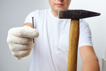 man with hammer in white gloves