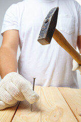 man with hammer in white gloves