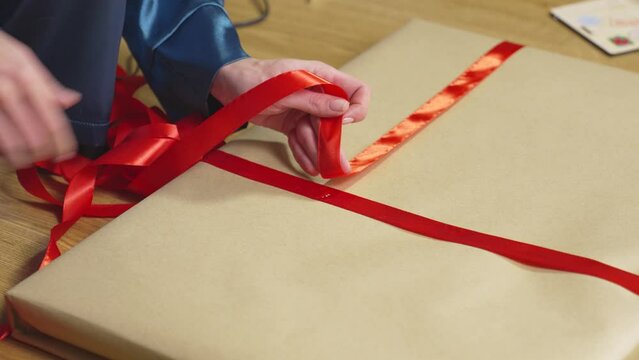 Trying on red ribbon and gluing it to craft