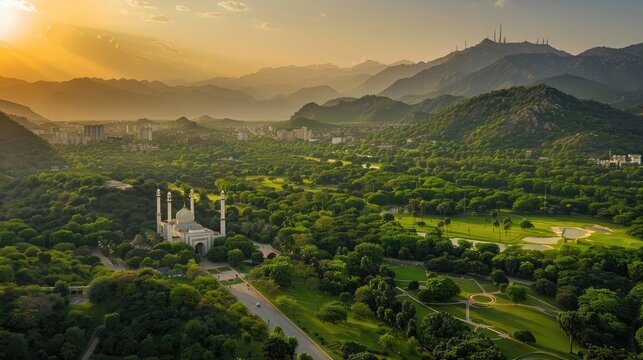 Fototapeta Aerial shot of Islamabad, the capital city of Pakistan showing the landmark Shah Faisal Mosque and the lush green mountains of Margala Hills