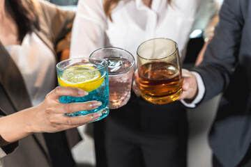 Close up group of people clinking glass of wines and cocktail in night party