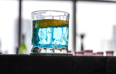 Close up glass of cocktail in night bar 