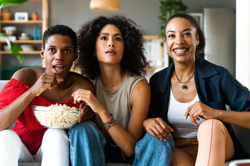 Three mixed race hispanic and black women bonding at home