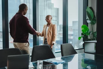  Successful business partners shaking hands in a corporate office © Jacob Lund