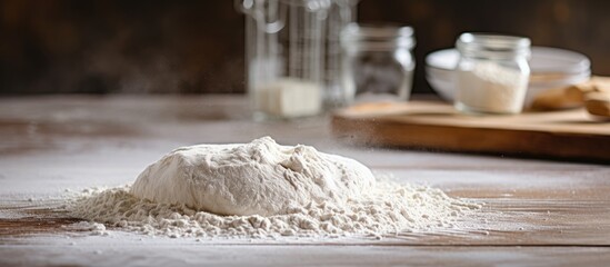 Flour pouring on heap wooden table