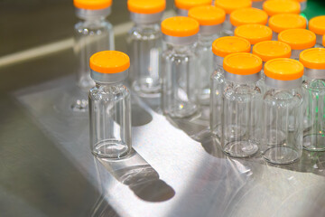 The set of pharmaceutical bottles with the orange cap.