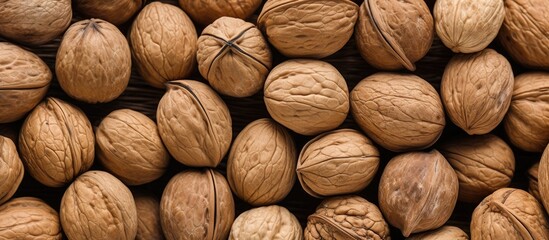 Pile of walnuts with nuts in center - obrazy, fototapety, plakaty
