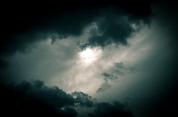 Stormy sky with dark clouds. Abstract nature background. Toned.