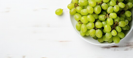 Bowl of grapes on white table