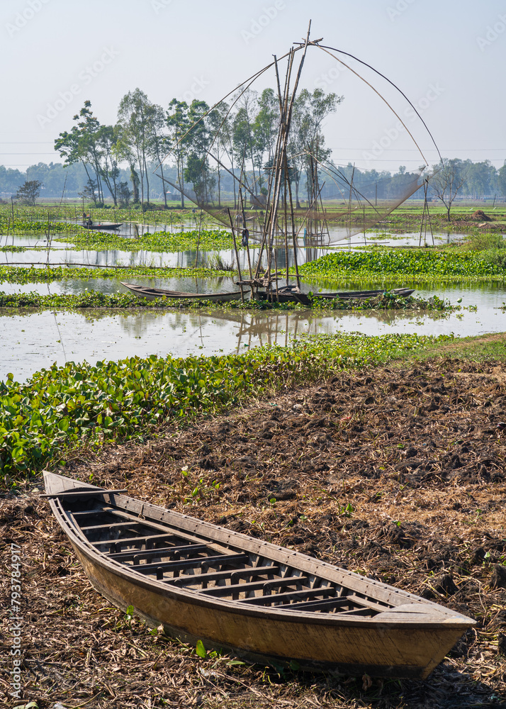 Canvas Prints Vertical rural landscape with wooden boats and chinese fishing net in Tangail countryside, Bangladesh