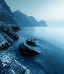 rocks in calm blue water with distant mountains - obrazy, fototapety, plakaty
