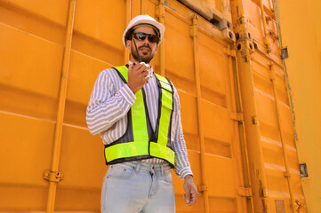 Portrait of a male engineer working in the shipping container industry, import-export of goods to the shipping business.
