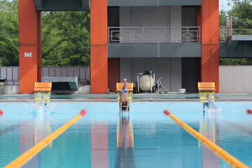 children are swimming in the pool