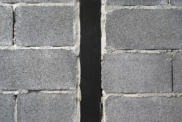 New concrete brick block wall texture background with black metal at center.