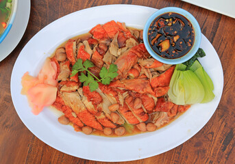 Sliced roasted duck served with sauce, bean and pickled ginger and vegetable on wood table background. Top view. - 793795737