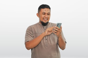 portrait of a man playing with an android cellphone on a white background