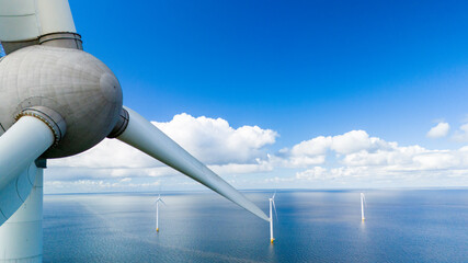 A lone wind turbine stands tall in the middle of the vast ocean, harnessing the power of the wind...