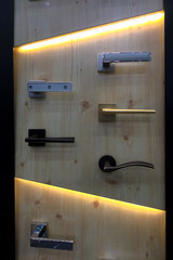 The stand presents different types of door handles for entrance doors.