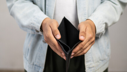 Worried unemployment man open empty wallet on payday. Broke person has no cash money in purse to...