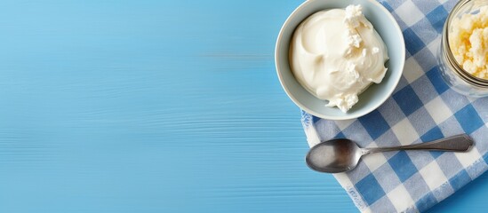 Fototapeta na wymiar A bowl of ice cream and a spoon on a blue table