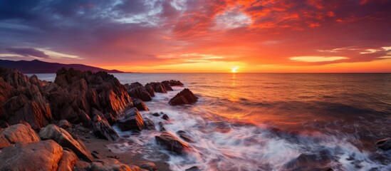 Sunset over the sea with rocks and waves - Powered by Adobe