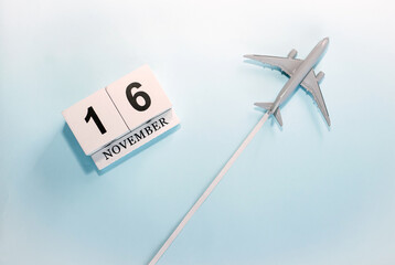 November calendar with number  16. Top view of a calendar with a flying passenger plane. Scheduler....