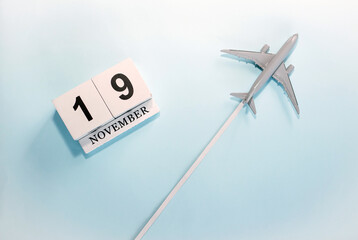 November calendar with number  19. Top view of a calendar with a flying passenger plane. Scheduler....