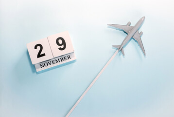 November calendar with number  29. Top view of a calendar with a flying passenger plane. Scheduler....