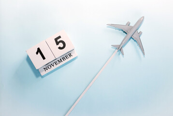November calendar with number  15. Top view of a calendar with a flying passenger plane. Scheduler....