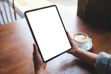 Mockup image of a woman holding digital tablet with blank white desktop screen in cafe - 793812560