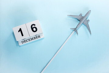 December calendar with number  16. Top view of a calendar with a flying passenger plane. Scheduler....