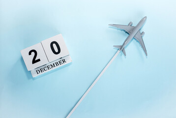 December calendar with number  20. Top view of a calendar with a flying passenger plane. Scheduler....