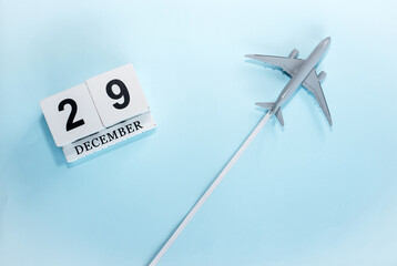 December calendar with number  29. Top view of a calendar with a flying passenger plane. Scheduler....