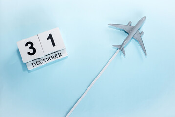 December calendar with number  31. Top view of a calendar with a flying passenger plane. Scheduler. Travel concept. Copy space.