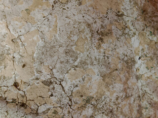 Rough, rough close-up view of the worn, textured surface of natural stone