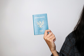 Hand Holds and Showing Indonesian Passport 