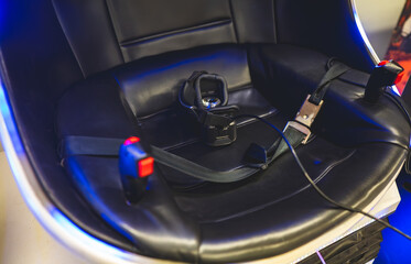 Virtual reality helmet in a special chair with controls.
