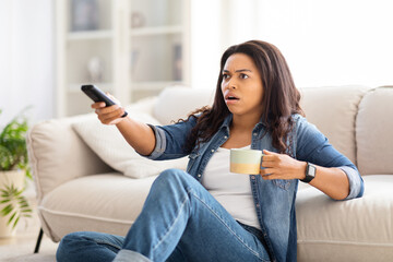 Woman Sitting on Floor Holding Remote Control