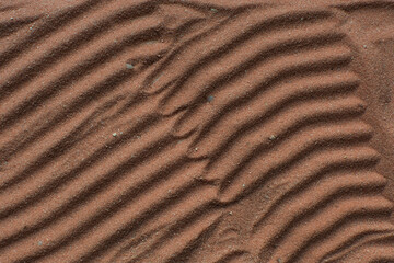 Lines drawn in brown sand background, beautiful sand texture, overhead view of chocolate brown sand, zen pattern drawn in the sand, Top view of fine grain texture