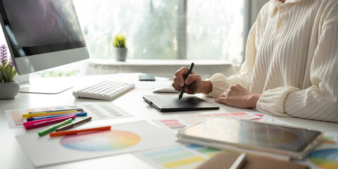 close up, designer working in graphic design Choose colors for working with computers at your office desk.