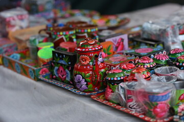 Stack of traditional Plates and handmade ceramics, handmade colorful dishes , Handicraft kettle item, Colorful Handmade Pottery and Ceramics, Souvenir Shop in lok virsa mela Islam
