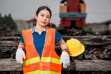 portrait Asian young teen engineer worker standing happy smile outdoor waring safety reflective with hardhat. - 793844312