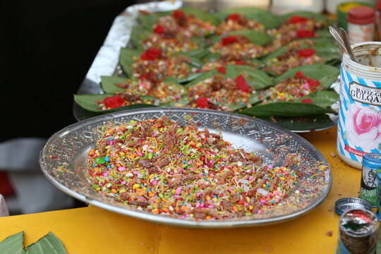 This is All testy sweet cherry metha khatta pan Nirmal, Banarasi paan or betel leaf garnished with betel nut and all indian colorful Banaras ingredients for sale at pous fair,
