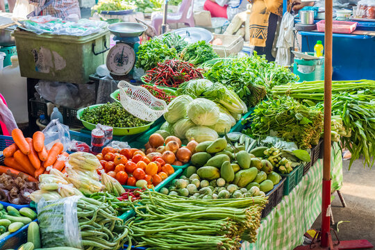 Variety of fresh vegetables are sold on the stalls for retail at the fresh food market.  Asparagus bean, onion, tomato, carrot, cucumber, pea eggplant, goat horn hot pepper, Thai green eggplant, etc.