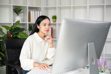 Beautiful business woman with determination Working on computer in home office