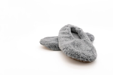 Fluffy gray home slippers isolated on white background. Bed shoes accessory footwear.
