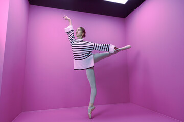 young ballerina in white tights and a half-skirt poses ballet steps standing on pointe shoes