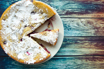 Tasty homemade sliced cake on wooden background, top view